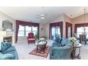 Spacious living room with plush seating, fireplace, and large windows with elegant valances at 5550 Crystal Bay W Dr, Plainfield, IN 46168