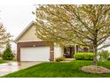 Attractive single-Gathering home with brick and siding exterior, a two-car garage, and a well-kept lawn at 5650 Goodwin St, Indianapolis, IN 46234