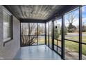 Enclosed porch with painted floor, brick wall and windows to the exterior at 6144 N Dearborn St, Indianapolis, IN 46220