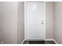 Interior shot of the front door, with white trim and gray patterned wall coverings at 9820 Legends Creek Dr # 103, Indianapolis, IN 46229