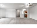 Open concept living room featuring neutral walls, carpet flooring, and a ceiling fan at 9820 Legends Creek Dr # 103, Indianapolis, IN 46229