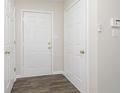 Clean entryway featuring wood-look floors, crisp white doors and walls, and modern fixtures at 12222 Split Granite Dr, Fishers, IN 46037