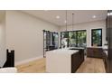 Contemporary kitchen featuring marble countertop island, stainless steel appliances, and ample natural light at 124 1St. Se Ave, Carmel, IN 46032
