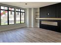 Spacious living room featuring modern fireplace, large windows, and hardwood floors at 124 1St. Se Ave, Carmel, IN 46032