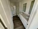Bathroom features double sinks, white cabinets, and glass enclosed shower at 1704 N Winthrop Rd, Muncie, IN 47304