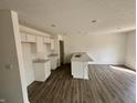 Bright kitchen features white cabinetry, stainless steel sink, and open layout at 1704 N Winthrop Rd, Muncie, IN 47304