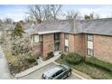 Brick condo building with well-maintained landscaping, sidewalk and ample parking at 2207 Rome Dr # B, Indianapolis, IN 46228