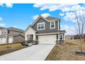 Attractive two-story home with a well-maintained lawn and a concrete driveway leading to the attached garage at 2705 Grassy Branch Dr, Whitestown, IN 46075