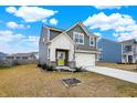 Well-kept two-story house featuring gray siding, white trim, a manicured lawn, and an attached two-car garage at 2705 Grassy Branch Dr, Whitestown, IN 46075