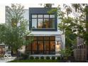 This modern home showcases a black trim and plenty of natural light through its many windows at 2719 Carrollton Ave, Indianapolis, IN 46205