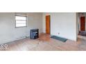 Bedroom with hardwood floors, a large window for natural light, and a closet or door to another space at 3842 Priscilla Ave, Indianapolis, IN 46226