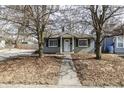 Inviting home featuring a well-kept lawn and a quaint front porch at 4221 Evanston Ave, Indianapolis, IN 46205