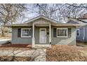 Charming home with gray paint, a welcoming front porch, and an inviting entrance at 4221 Evanston Ave, Indianapolis, IN 46205