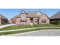 Attractive brick home featuring a well-kept lawn, black shutters, and a two-car garage, inviting curb appeal at 4248 Stone Lake Dr, Zionsville, IN 46077