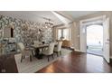 Open-concept dining room featuring hardwood floors, stylish furniture, and decorative wallpaper at 4431 Hickory Stick Row, Greenwood, IN 46143