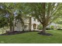Charming two-story brick home with a well-manicured lawn and mature trees, reflecting classic suburban elegance at 4906 Willow Ridge Ct, Zionsville, IN 46077