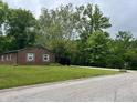 Beautifully maintained brick ranch home featuring a spacious front yard and mature trees at 530 Lansdowne Rd, Indianapolis, IN 46234