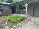 Inviting covered front porch with decorative plants and an ADT security system sign at 530 Lansdowne Rd, Indianapolis, IN 46234