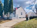 Exterior view of a quaint home, showcasing the lawn and detached garage at 5317 E 20Th Pl, Indianapolis, IN 46218
