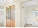 Bright hallway with wood closet doors, fresh paint, and carpet floors throughout at 5549 Hollister Dr, Indianapolis, IN 46224