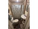 Modest bathroom area with toilet, sink and shower at 712 Lynn St, Indianapolis, IN 46222