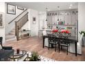 Open-concept living space showcasing a modern kitchen, staircase, and stylish dining area for seamless entertaining at 746 Astor Dr, Carmel, IN 46032