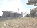 Single-story brick and siding home on a sprawling lawn in the countryside with an American flag at 7811 W 700 S, Jamestown, IN 46147