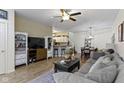 Open-concept living area with a ceiling fan, wood floors, and a large sofa at 9543 Brightwell Dr, Indianapolis, IN 46260
