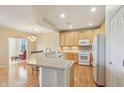 Well-lit kitchen features natural wood cabinets, modern appliances, and ample countertop space at 12880 Oxbridge Pl, Fishers, IN 46037