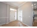 Bright foyer with hardwood floors, white trim, and glass paneled doors leading to another room at 12964 Walbeck Dr, Fishers, IN 46037