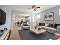 Inviting living room with hardwood floors, comfortable seating, and an open flow to the kitchen at 12964 Walbeck Dr, Fishers, IN 46037