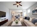 Bright, open-concept living room and kitchen area with modern furnishings and natural light at 12964 Walbeck Dr, Fishers, IN 46037