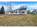 Side view of a single-story home featuring vinyl siding, an attached garage, and a well-maintained lawn at 1818 Arlene Dr, Indianapolis, IN 46219