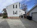 Exterior view of the back of the house, showcasing the deck and well-maintained gravel yard at 1905 Apple St, Greenfield, IN 46140