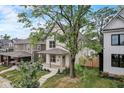 View of home with a covered front porch, landscaped yard, and a mature tree at 206 N Hamilton Ave, Indianapolis, IN 46201