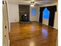 Spacious living room featuring hardwood floors, brick fireplace with wood-burning stove, and abundant natural light at 2070 E 100 S, Lebanon, IN 46052