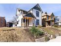 Charming renovated two-story home with inviting front porch and mature landscaping at 2110 N Talbott St, Indianapolis, IN 46202