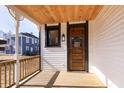 Cozy front porch with wood ceiling leads to the beautiful paneled front door at 2110 N Talbott St, Indianapolis, IN 46202