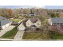 An aerial view of a suburban two-story home featuring a yellow exterior and a well-kept lawn at 21360 Oakview Dr, Noblesville, IN 46062