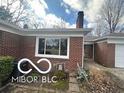 Well-maintained brick home featuring a tidy yard and a convenient attached garage at 3233 E 48Th St, Indianapolis, IN 46205