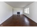 Inviting living room boasts a cozy fireplace, hardwood floors, and a bright, airy atmosphere at 3233 E 48Th St, Indianapolis, IN 46205