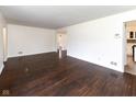 Spacious living area with gleaming hardwood floors, offering a versatile layout for entertaining at 3233 E 48Th St, Indianapolis, IN 46205