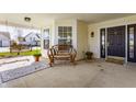 Relaxing front porch with bench, rug, and hanging swing, perfect for enjoying the outdoors at 3841 Constitution Dr, Carmel, IN 46032