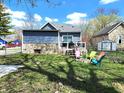 Backyard featuring a patio, open lawn, and a colorful seating area around a fire pit at 422 Johnson Ave, Franklin, IN 46131