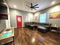 Open-concept living room with modern lighting, refinished hard wood floors, and neutral paint at 422 Johnson Ave, Franklin, IN 46131