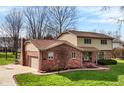 Charming two-story home with brick and vinyl siding, well-manicured lawn, and attached two-car garage at 502 Ironwood Dr, Carmel, IN 46033