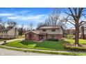 Two-story home with a well-maintained lawn, mature trees, and a brick and vinyl exterior at 502 Ironwood Dr, Carmel, IN 46033