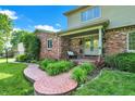 Charming front porch with brick walkway, decorative bench, and potted plants enhance curb appeal at 502 Ironwood Dr, Carmel, IN 46033