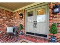 Inviting front porch with double doors, brick accents, stylish lighting, and comfortable seating at 502 Ironwood Dr, Carmel, IN 46033