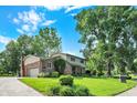 Beautifully landscaped two-story home with a brick facade, attached garage, and verdant lawn at 502 Ironwood Dr, Carmel, IN 46033